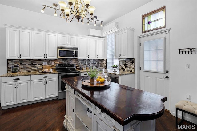 1317 Shenandoah Ave, Saint Louis, MO 63104 - kitchen featuring appliances with stainless steel finishes, wooden counters, decorative backsplash, white cabinetry, and dark wood-style floors
