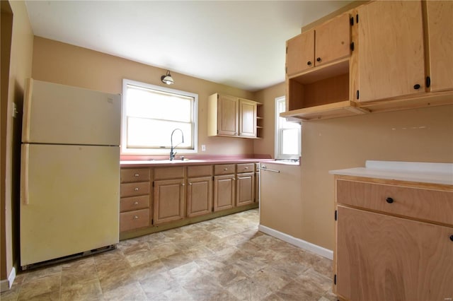 610 Panhorst St, Staunton, IL 62088 - kitchen featuring freestanding refrigerator, a sink, open shelves, and light brown cabinets