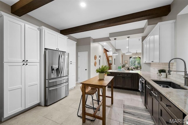 kitchen with stainless steel appliances, a sink, beam ceiling, recessed lighting, and decorative backsplash