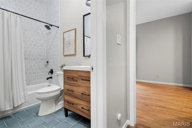 full bathroom featuring toilet, shower / bath combo, vanity, and tile patterned flooring