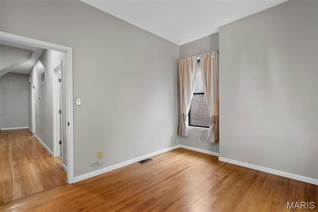 empty room with wood finished floors and baseboards