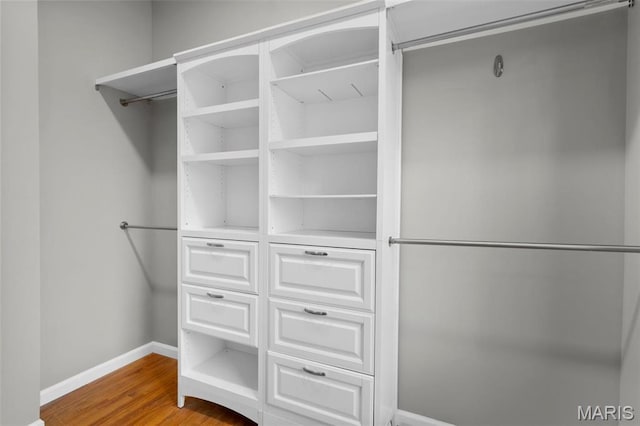 spacious closet with wood finished floors