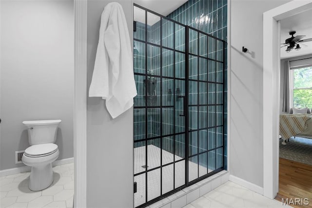 full bathroom featuring a stall shower, connected bathroom, ceiling fan, toilet, and baseboards