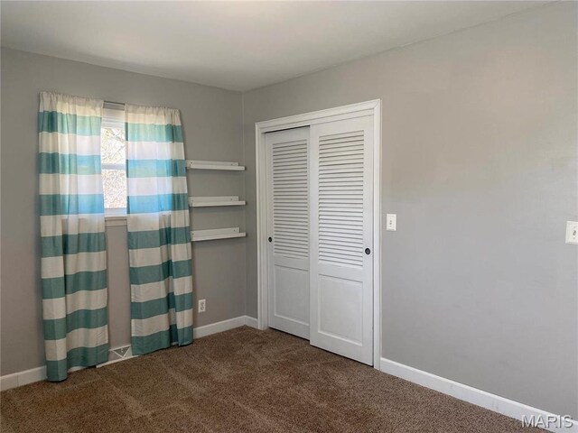 2 El Rancho Dr, Hannibal, MO 63401 - unfurnished bedroom with carpet floors, baseboards, and a closet