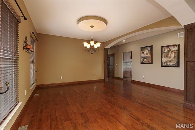 9606 Klings Ct, Mascoutah, IL 62258 - unfurnished room featuring a chandelier, wood-type flooring, baseboards, and arched walkways