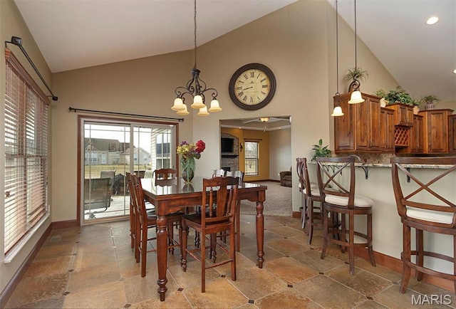 9606 Klings Ct, Mascoutah, IL 62258 - dining area with high vaulted ceiling, baseboards, a chandelier, recessed lighting, and stone finish flooring