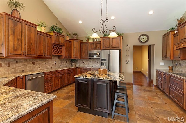9606 Klings Ct, Mascoutah, IL 62258 - kitchen with stainless steel appliances, light stone countertops, backsplash, a kitchen breakfast bar, and hanging light fixtures
