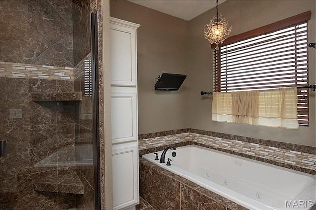 9606 Klings Ct, Mascoutah, IL 62258 - full bathroom featuring a whirlpool tub, a shower stall, and a chandelier