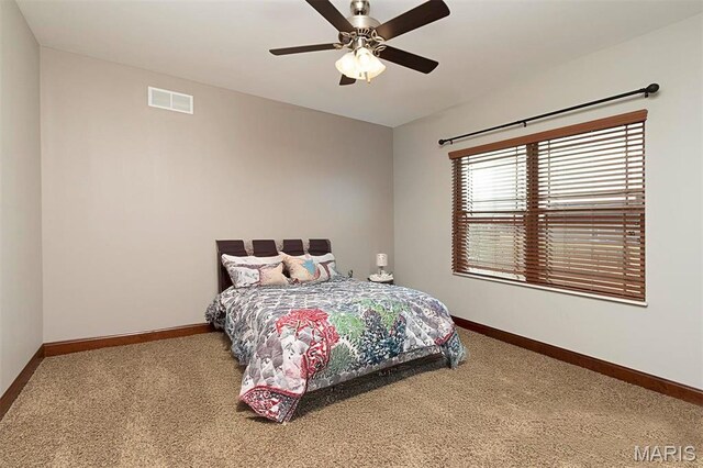9606 Klings Ct, Mascoutah, IL 62258 - carpeted bedroom with baseboards and a ceiling fan