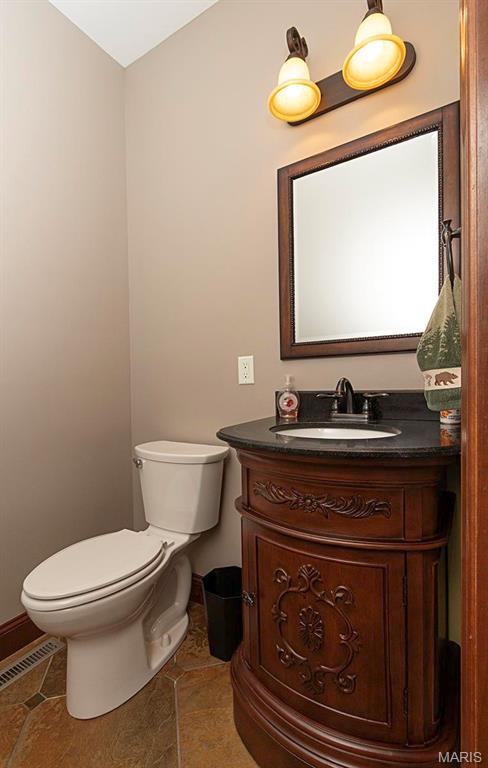 9606 Klings Ct, Mascoutah, IL 62258 - half bathroom with toilet, tile patterned flooring, vanity, and baseboards