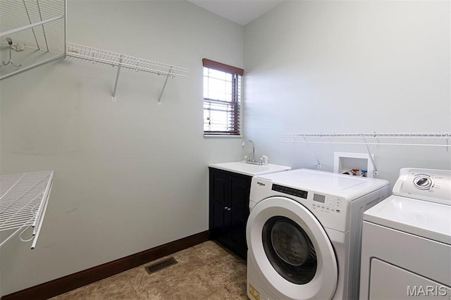 9606 Klings Ct, Mascoutah, IL 62258 - laundry room featuring independent washer and dryer, cabinet space, and baseboards