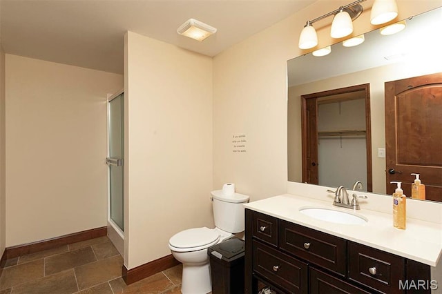 9606 Klings Ct, Mascoutah, IL 62258 - bathroom featuring a stall shower, toilet, vanity, and baseboards