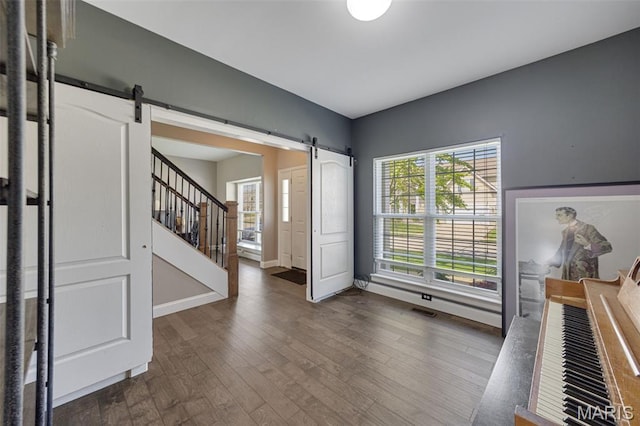 1218 Cold Spring Dr, Ofallon, MO 63368 - foyer featuring a barn door, dark wood-style flooring, and baseboards