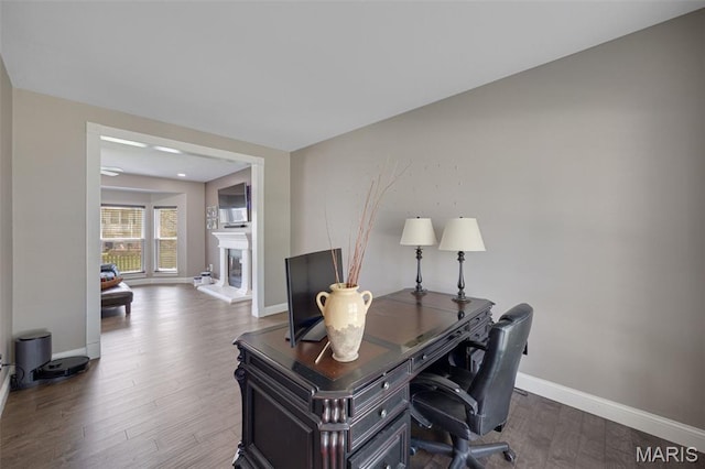 1218 Cold Spring Dr, Ofallon, MO 63368 - home office featuring baseboards, wood finished floors, and a glass covered fireplace