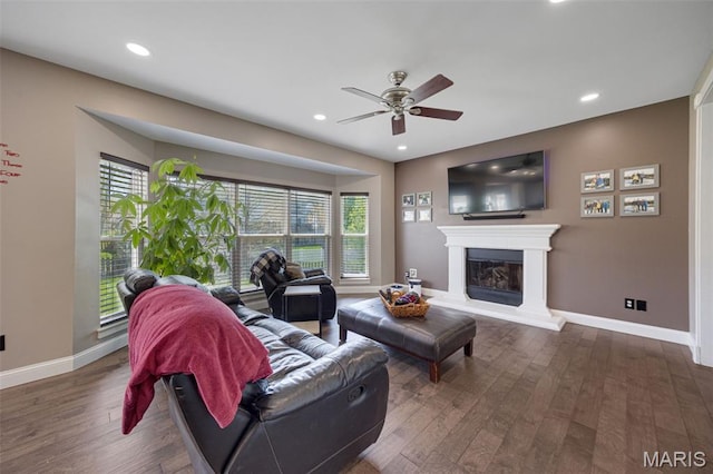 1218 Cold Spring Dr, Ofallon, MO 63368 - living room featuring ceiling fan, wood finished floors, baseboards, a glass covered fireplace, and recessed lighting