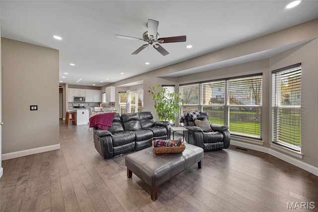 1218 Cold Spring Dr, Ofallon, MO 63368 - living area with healthy amount of natural light, ceiling fan, wood finished floors, and recessed lighting