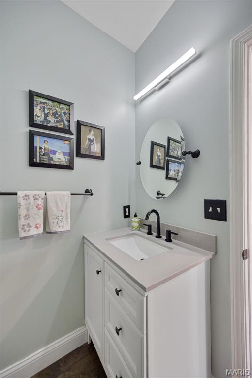 1218 Cold Spring Dr, Ofallon, MO 63368 - bathroom with vanity, baseboards, and wood finished floors