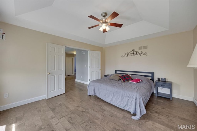 1218 Cold Spring Dr, Ofallon, MO 63368 - bedroom featuring a raised ceiling, wood finished floors, and baseboards