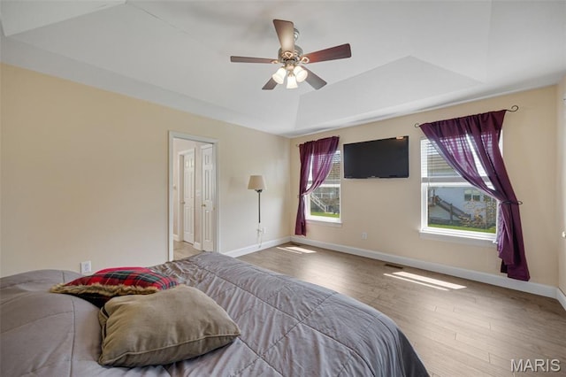 1218 Cold Spring Dr, Ofallon, MO 63368 - bedroom featuring a raised ceiling, baseboards, wood finished floors, and ceiling fan