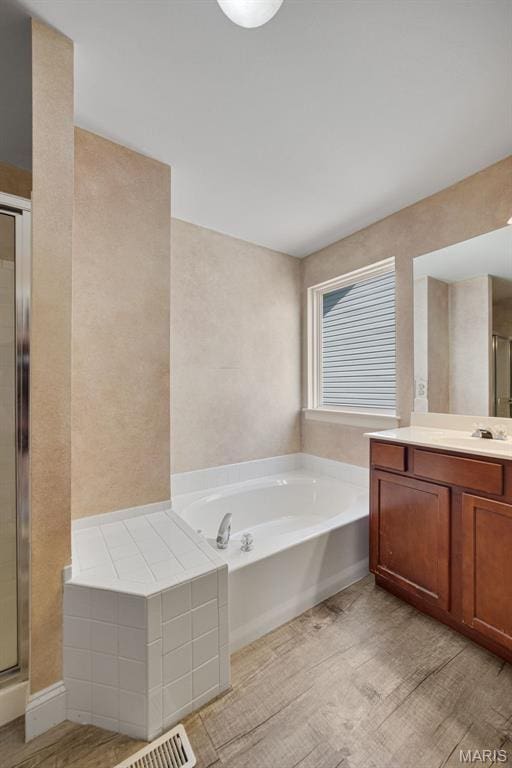 1218 Cold Spring Dr, Ofallon, MO 63368 - full bath featuring vanity, a garden tub, and a stall shower