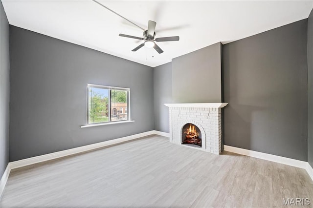 4649 Louisiana Ave, Saint Louis, MO 63111 - unfurnished living room with wood finished floors, a fireplace, a ceiling fan, and baseboards