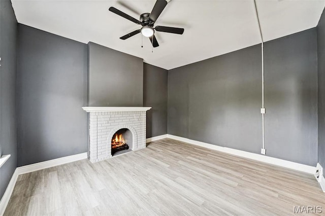 4649 Louisiana Ave, Saint Louis, MO 63111 - unfurnished living room with wood finished floors, a ceiling fan, a fireplace, and baseboards