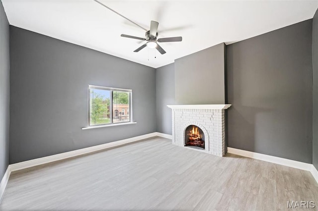 4649 Louisiana Ave, Saint Louis, MO 63111 - unfurnished living room featuring wood finished floors, a fireplace, a ceiling fan, and baseboards