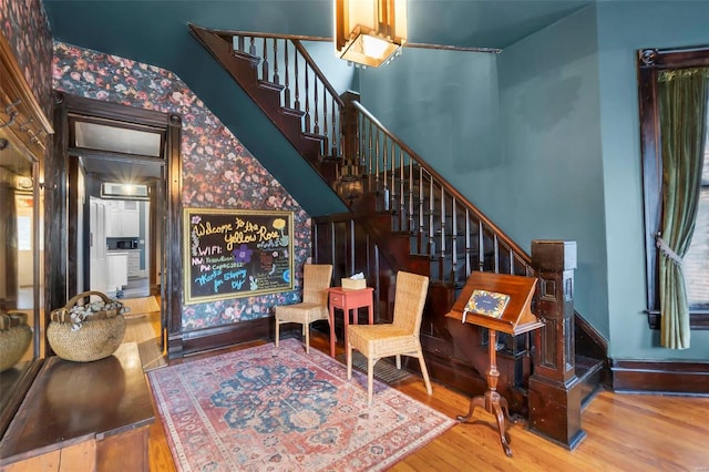 34 N Fountain Cpe, Girardeau, MO 63701 - foyer entrance featuring wood finished floors, stairway, wallpapered walls, and baseboards