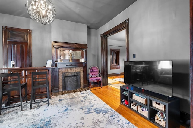 34 N Fountain Cpe, Girardeau, MO 63701 - living room featuring a fireplace with flush hearth, wood finished floors, and a chandelier