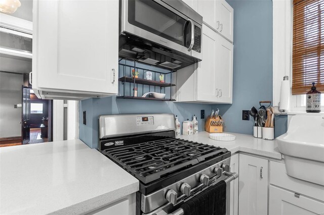 34 N Fountain Cpe, Girardeau, MO 63701 - kitchen with stainless steel appliances, white cabinetry, and light countertops