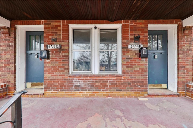 property entrance with brick siding