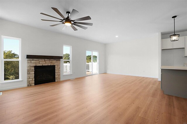 49 Back Ln Unit 49Stb, Washington, MO 63090 - unfurnished living room featuring light wood-type flooring, ceiling fan, a fireplace, baseboards, and recessed lighting