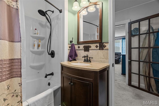 full bath featuring shower / tub combo with curtain, vanity, and backsplash