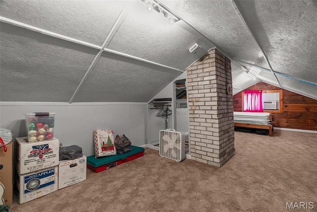 additional living space with a textured ceiling, vaulted ceiling, carpet floors, and cooling unit