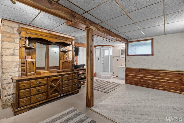 basement with a paneled ceiling