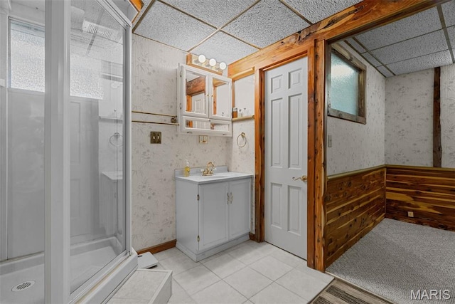 full bath featuring wallpapered walls, a shower stall, vanity, and tile patterned floors
