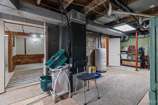 unfinished basement featuring water heater and heating unit