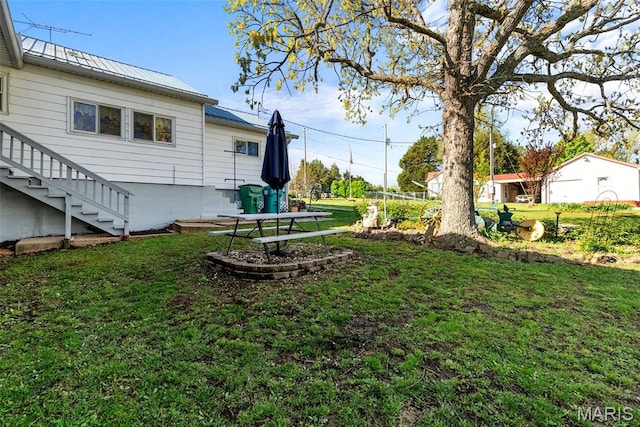 view of green lawn featuring stairs