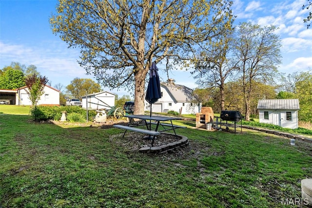 view of grassy yard with an outbuilding and a playground