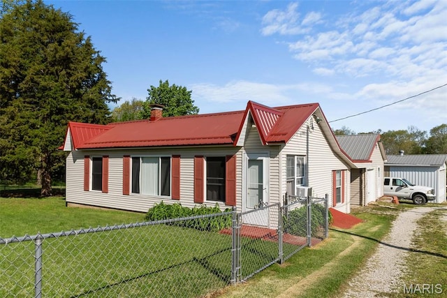 view of front of house featuring metal roof, driveway, a gate, and a chimney