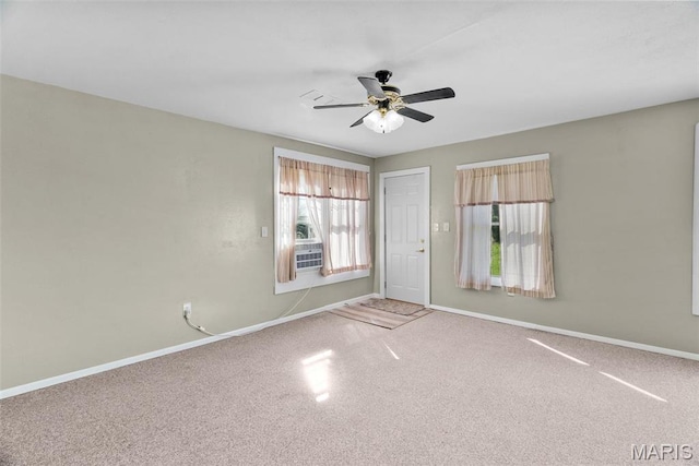 spare room with carpet flooring, baseboards, and a ceiling fan