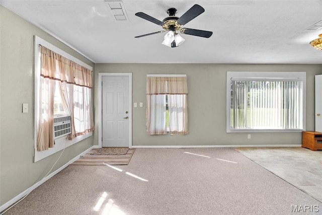foyer entrance with carpet floors, baseboards, and ceiling fan