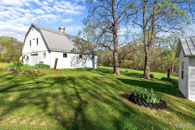 view of green lawn with a barn and an outdoor structure
