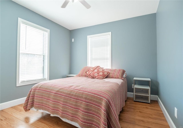 601 Broadway St, Van Buren, MO 63965 - bedroom with multiple windows, wood finished floors, baseboards, and ceiling fan