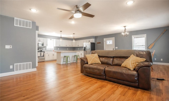 601 Broadway St, Van Buren, MO 63965 - living area featuring a ceiling fan, baseboards, a chandelier, light wood finished floors, and recessed lighting
