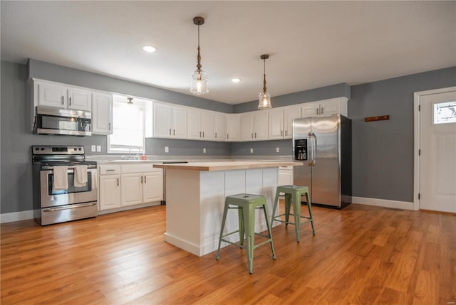 601 Broadway St, Van Buren, MO 63965 - kitchen featuring stainless steel appliances, light countertops, white cabinetry, baseboards, and recessed lighting