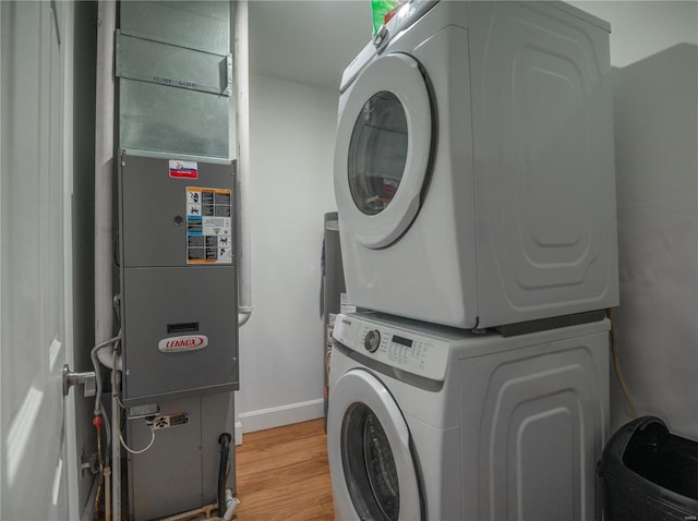 601 Broadway St, Van Buren, MO 63965 - laundry room featuring stacked washer and clothes dryer, baseboards, and light wood-style floors