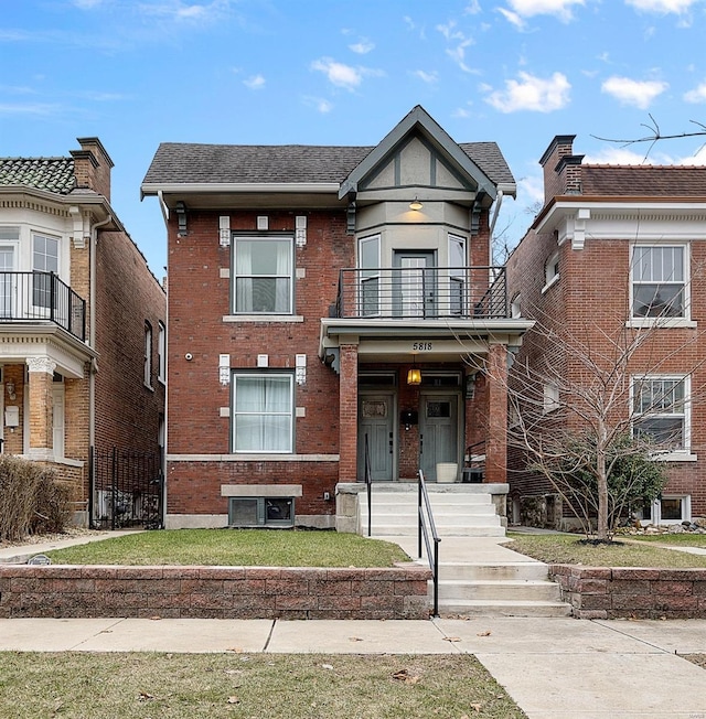 5818 Westminster Pl, Saint Louis, MO 63112 - view of front of home with a balcony, brick siding, and a shingled roof