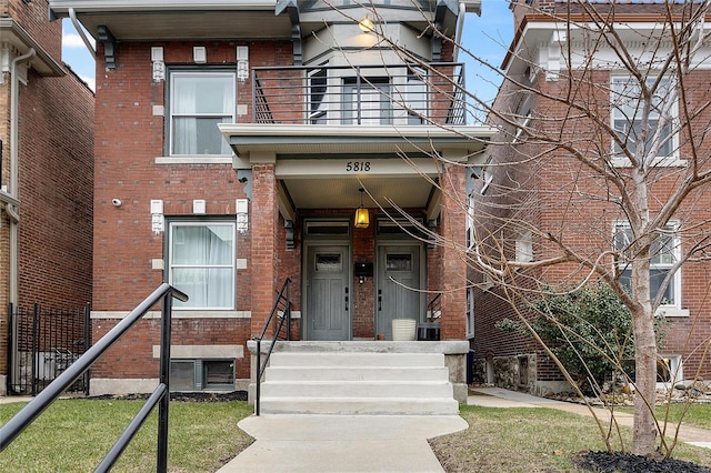 5818 Westminster Pl, Saint Louis, MO 63112 - entrance to property with a balcony, brick siding, fence, and cooling unit
