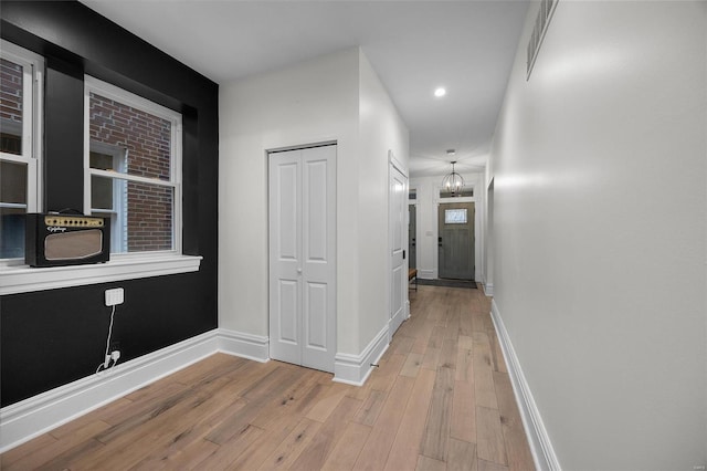 5818 Westminster Pl, Saint Louis, MO 63112 - hall featuring light wood-style flooring, baseboards, recessed lighting, and a chandelier